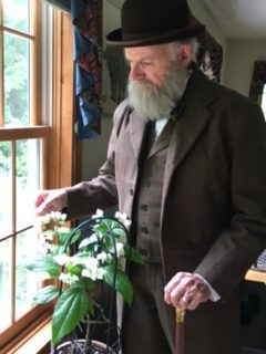 Noll as Darwin with plant